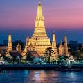 Scenic tropical beach with crystal-clear turquoise water and traditional longtail boats in Thailand